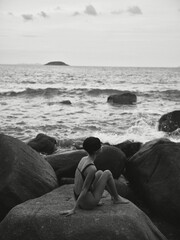 Beauty in the Water: Sensual Summer Escape of a Slim Woman in Black and White Swimwear on a Sunny Beach