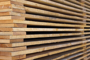 Warehouse of wooden boards of different sizes for construction and production.