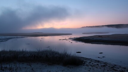 Fog rolling through an estuary at sunrise, creating an ethereal and mystical atmosphere.