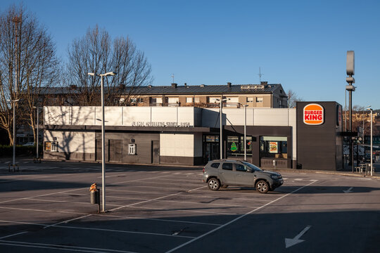 Vila Nova de Famalicao, Portugal - December 23, 2023: Burger King fast food franchise restaurant seen from an empty parking lot area before opening hours. Hamburger fast food meal