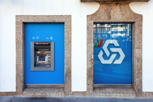 Vila Nova de Famalicao, Portugal - December 23, 2023: Multibanco aka ATM machine terminal managed by SIBS, with brand logo, sign or symbol of CGD aka Caixa Geral de Depositos on a bank agency