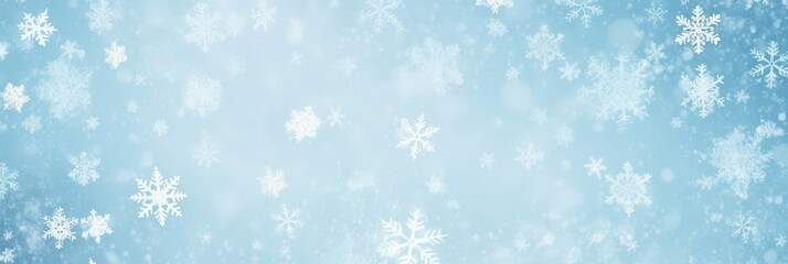 Delicate snowflakes gently falling against a pale blue winter sky background