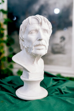 Bust of an elderly man displayed on a green fabric