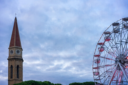 Arezzo Cathedral Tower and Ferris Wheel at Dusk in Tuscany