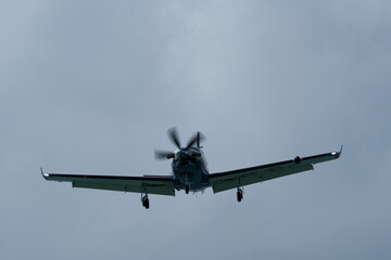 Single-engined turboprop airplane in the cloudy sky.