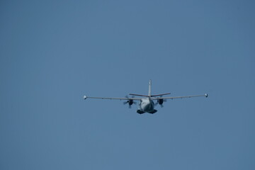Twin-engine short-range transport aircraft in the cloudy sky.