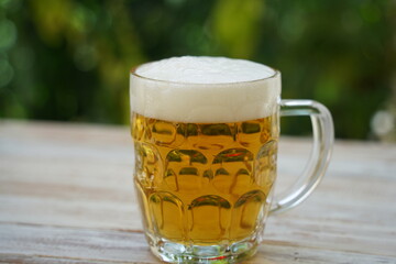 Beer mug on the table with beer. Pilsner lager golden beer