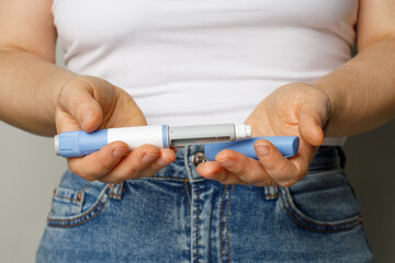 Diabetes blue Insulin or Semaglutide Injection pen closeup. Semaglutide or insulin drug against...