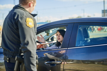 Woman, upset and traffic officer with ticket for checkpoint, security and crime investigation on...