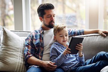 Father, son and home on sofa with tablet, family together and browsing internet for kids shows or...