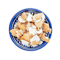 Pile of broken eggshell in a round bowl isolated