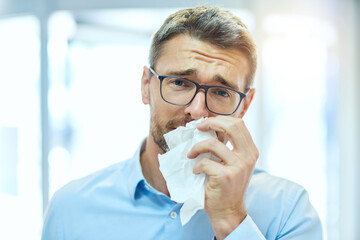 Mature man, portrait and sick with tissue for blowing nose, allergies and hayfever with virus infection. Healthcare, person and flu symptoms with illness from particles bacteria, disease or unhappy