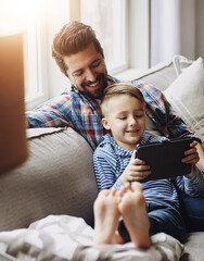 Father, boy and tablet on sofa with internet for educational gaming, movie bonding and online tv...