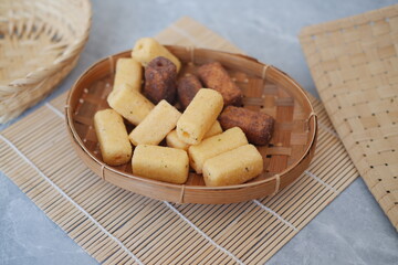 deep fried crackers in bamboo basket on gray background. Asian food