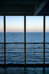View of a ferry boat window cruising on the sea at sunset