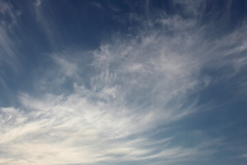 Blue sky with clouds. Cloudy sky landscape, silver cirrus clouds background, afternoon time. Atmosheric phenomenom, meteorology. White transparent  clouds, air, sun light in the high.