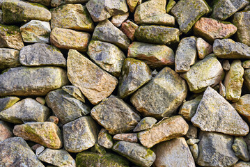 A wall background made of stone and red clay.