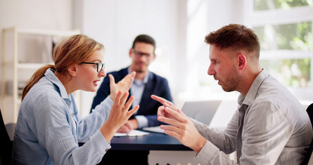 Professional lawyers mediating a tense argument between a young Hispanic couple