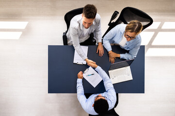 Professional Consultant Guide Couple in Meeting with Advisor