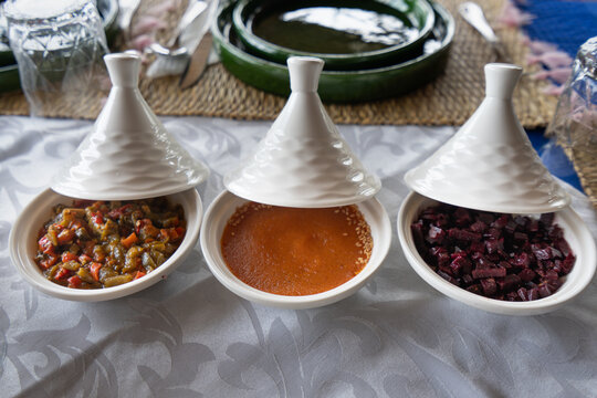 Close-up view of traditional Moroccan vegetable tagines, showcasing the vibrant colors and textures of the dishes. A delightful culinary experience on the journey to Chefchaouen, Morocco.
