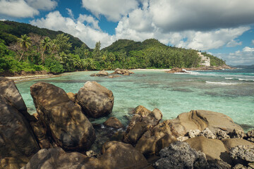 Tropical Paradise: Scenic Beach and Crystal Clear Waters with Rocky Shoreline and Lush Greenery, Mahé, Seychelles