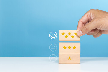 Service rating, satisfaction and positive feedback concept. A man choose wooden cube with smile...