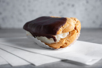 A closeup view of an eclair, dipped in chocolate.