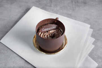 A view of a cappuccino chocolate cup pastry.