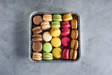 A top down view of a tray of assorted macaron cookies.