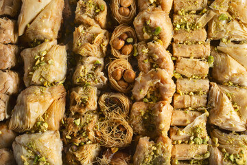 A top down view of a tray of assorted baklava pastries.