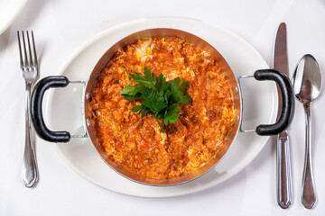 Turkish traditional menemen dish made with eggs, onions, peppers and tomatoes