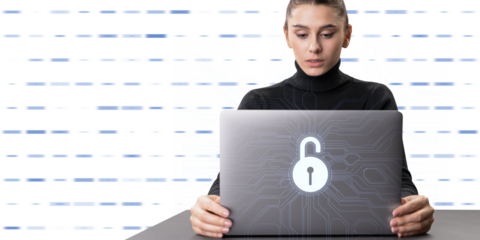 A woman using a laptop with a digital lock symbol on the screen, symbolizing cybersecurity, against a striped background