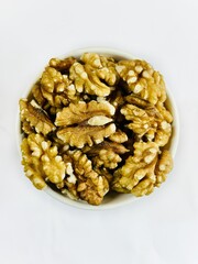 A bowl of walnuts on top view 