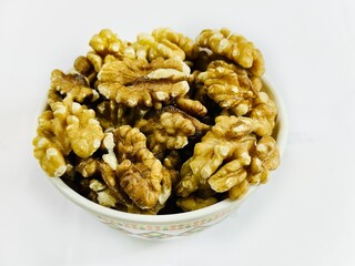 A bowl of dried walnuts on white background 