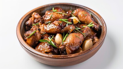 A dish of Filipino adobo with chicken and garlic on a white background.
