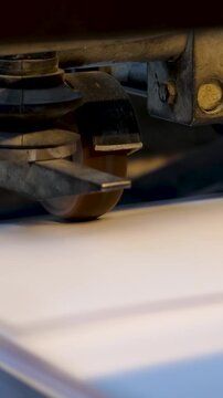 Printing machine print paper in typography. Pages are rapidly moving through conveyor belt line 