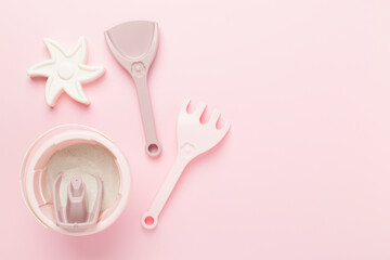 Cute toys for playing with sand on color background, top view
