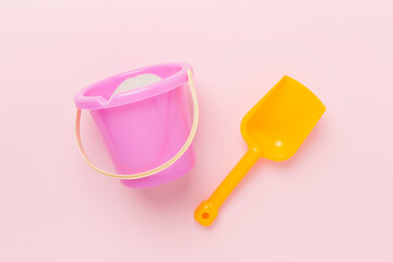 Cute toys for playing with sand on color background, top view