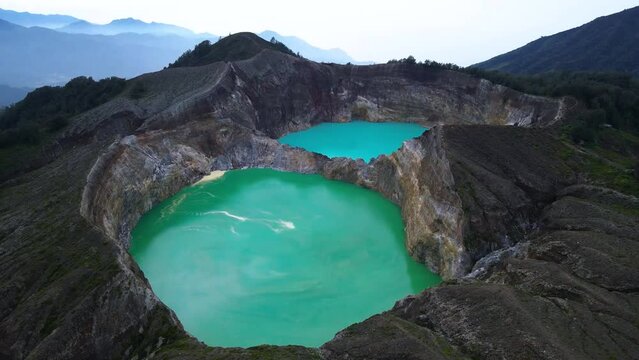 twin lakes formed from volcanic eruptions side by side with bright green and blue water, Kelimutu Lake of Flores Island Indonesia