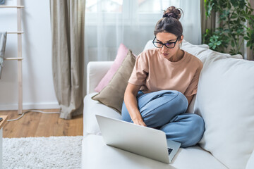 Young unemployed jobless woman sitting at home hoping for easy money and quick cash earnings from...