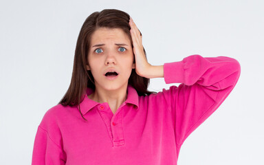 Photo of shocked afraid cute girl open mouth hand on head wear pink sweatshirt isolated white background