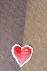 paper heart on brown paper with weave pattern
