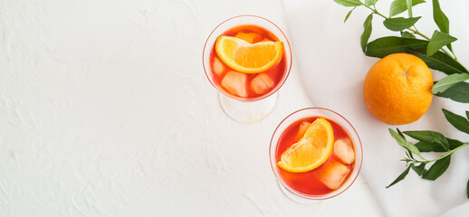 Glasses of Aperol spritz cocktail on light background