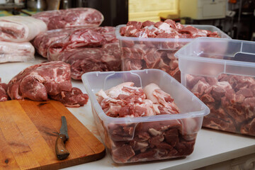 Pork meat that has been raw is prepared for marinating before being grilled on barbecue BBQ