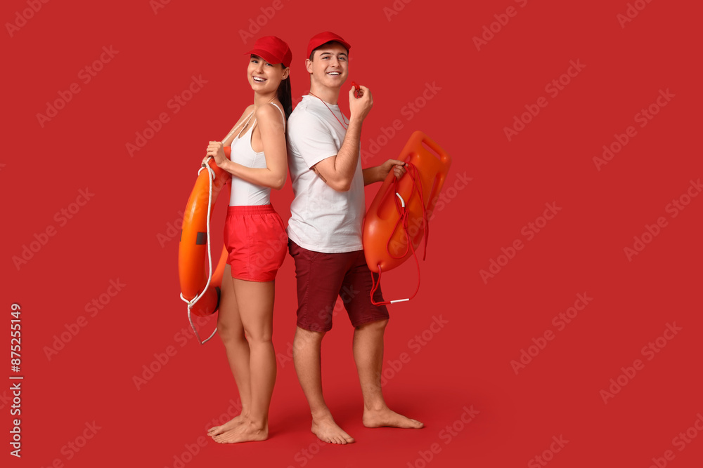 Canvas Prints Lifeguards with ring buoy and rescue tube on red background