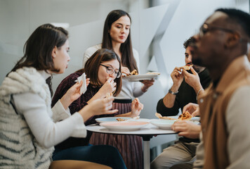 Successful multiracial business people enjoying a relaxing lunch break together.