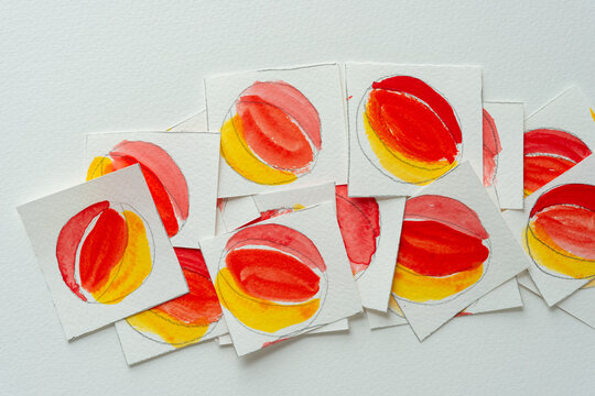 overlapping paper tiles with abstract yellow orange and red circular pattern 