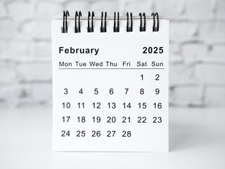 February 2025 white monthly desk calendar on a table