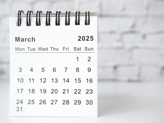 March 2025 white monthly desk calendar on a table