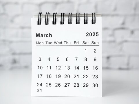 March 2025 white monthly desk calendar on a table